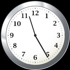 A round silver wall clock showing the time as 11:25. The hour hand is between 11 and 12, and the minute hand points at 5.